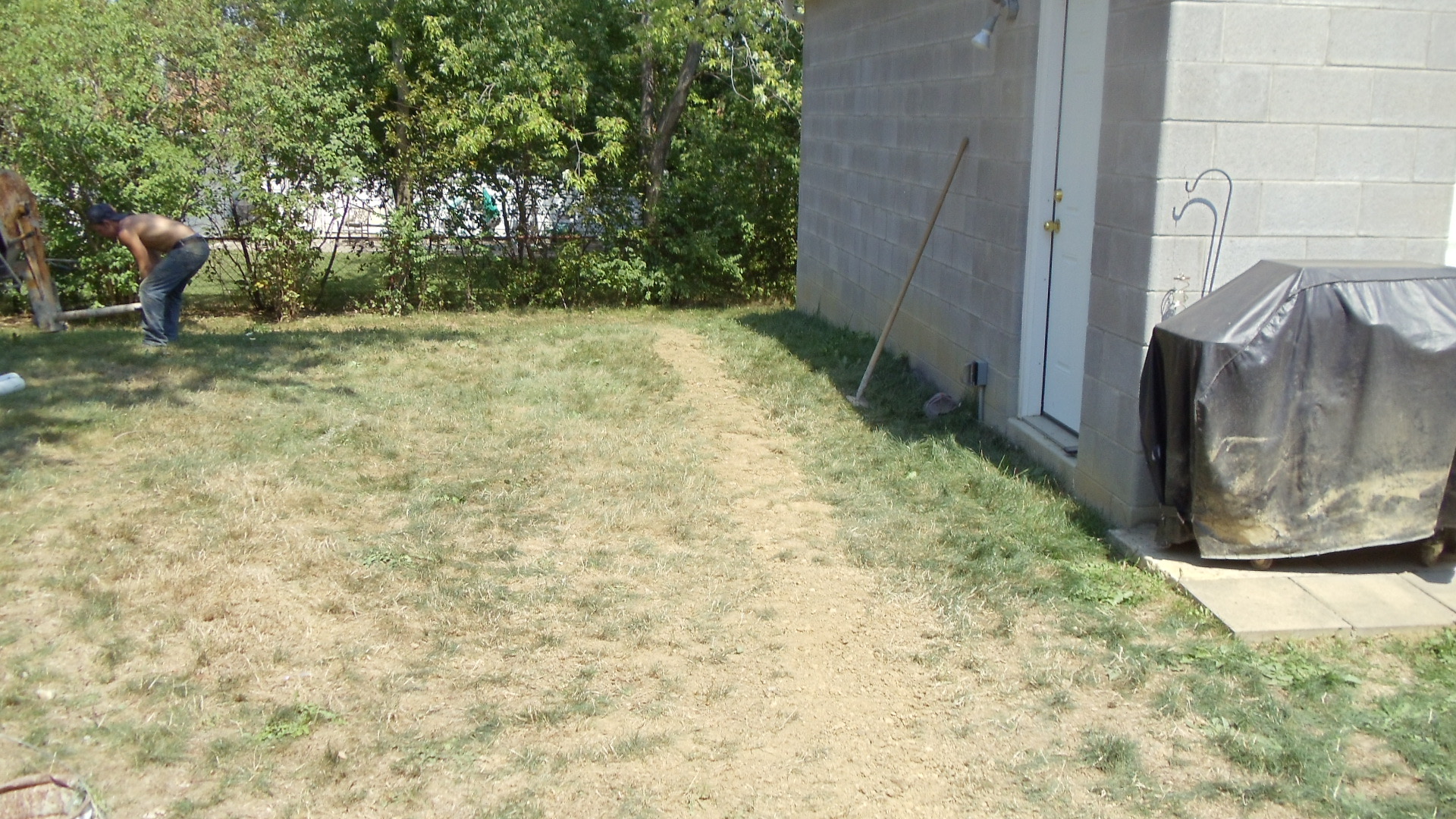 ABS crew member positioning drainage line during installation